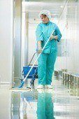 Medical office cleaners mopping a clinic floor with antiseptic technique. Doctor's offices and hospitals can benefit from daily medical facility cleaning in NYC, medical office cleaning nyc.