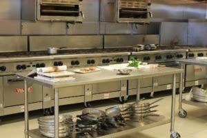 image of a restaurant kitchen. Cleaning services in New York city help ensure that all facets of the kitchen are cleaned including the kitchen exhaust hood. Cleaning NYC commercial kitchens is performed by professional companies like SanMar.