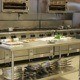 image of a restaurant kitchen. Cleaning services in New York city help ensure that all facets of the kitchen are cleaned including the kitchen exhaust hood. Cleaning NYC commercial kitchens is performed by professional companies like SanMar.