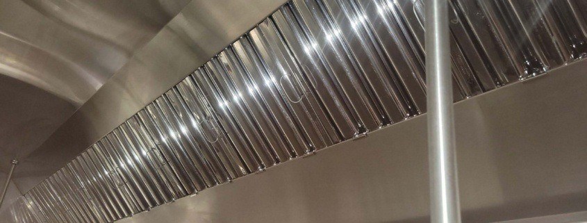 Image of a clean kitchen hood. Exhaust hood cleaning services are a crucial part of fire prevention for restaurants in NYC.