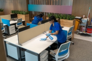 New York City janitors wiping down workstations in an commercial office building.