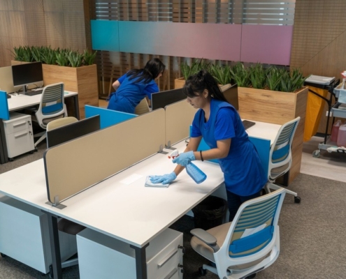 New York City janitors wiping down workstations in an commercial office building.