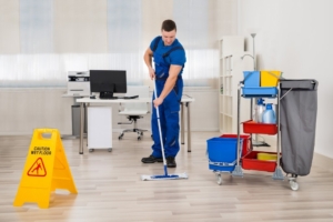 Office cleaner mopping the floor.