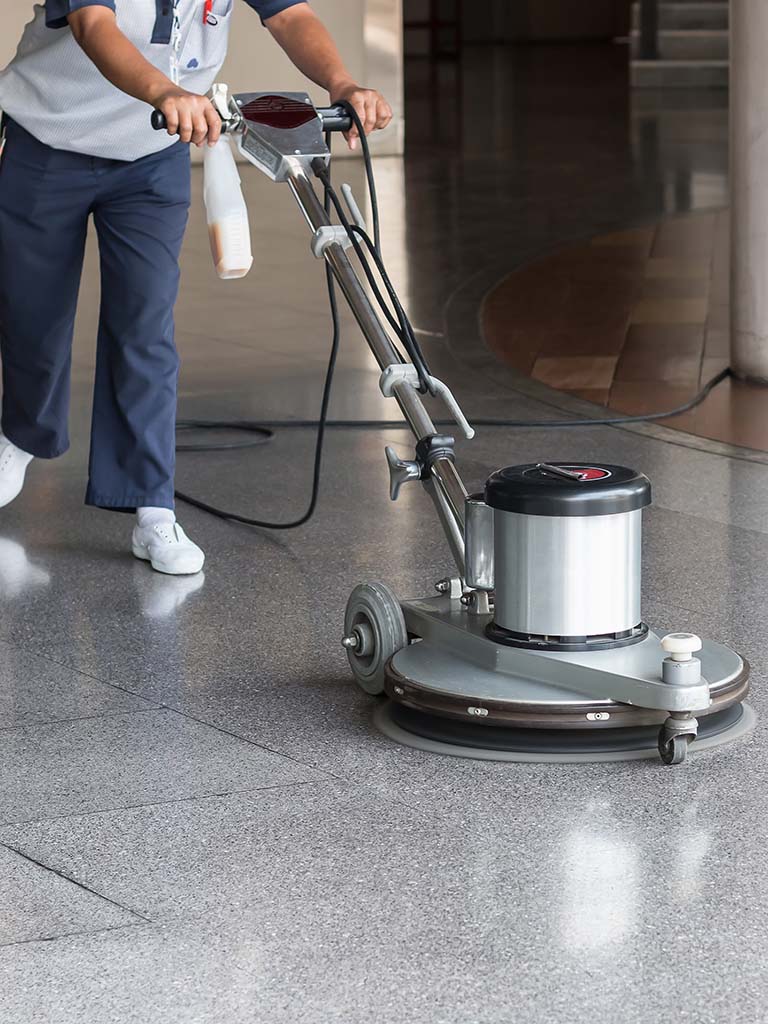 New York City floor care technician polishing office building floors, downtown Manhattan, NY.