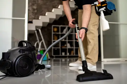 SanMar Building Services janitorial floor cleaning team member preparing a commercial vacuum to maintain your corporate work environment.